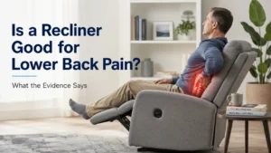 Man sitting in a recliner with lower back pain highlighted, illustrating the question: Is a recliner good for lower back pain?